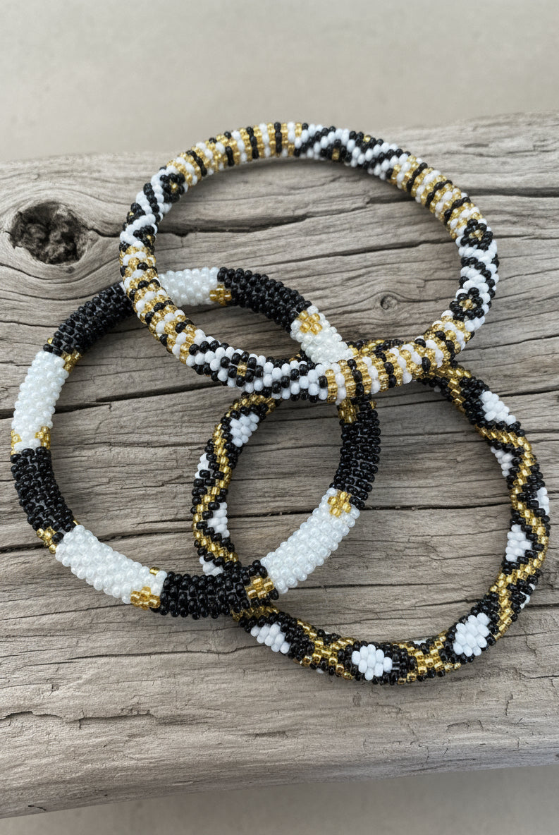 three beaded racelet on a wooden background
