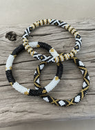 three beaded racelet on a wooden background