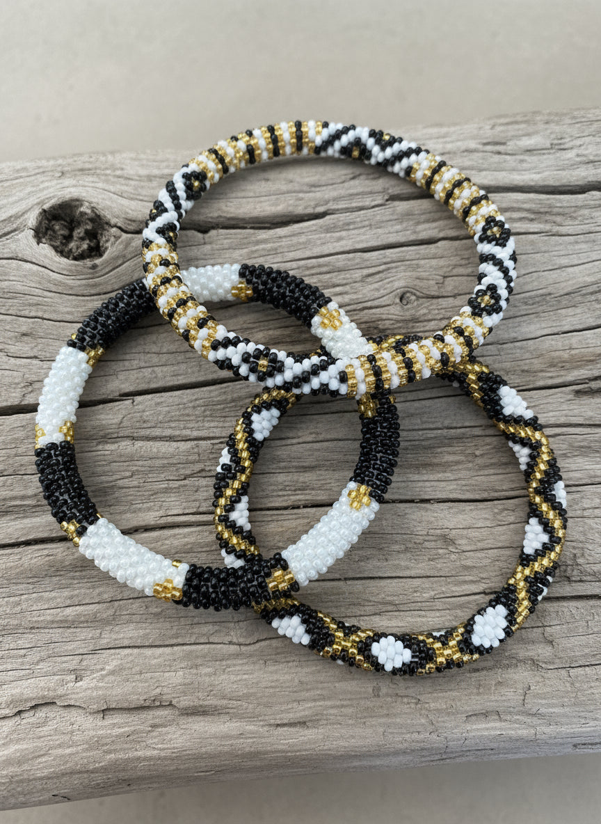 three beaded racelet on a wooden background